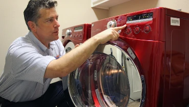 Mr. Appliance technician servicing a washer and dryer