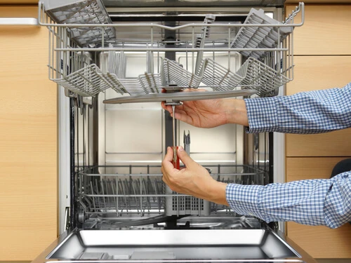 Appliance tech servicing a dishwasher