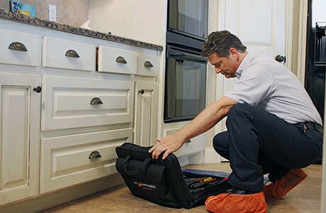 A Mr. Appliance technician preparing to diagnose an appliance issue.