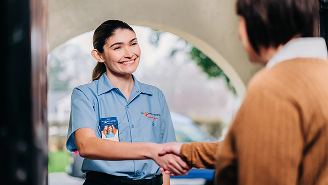Mr. Appliance service professional shaking hands with customer.