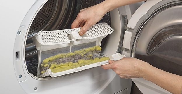 A closeup shot of a dirty dryer vent lint trap.