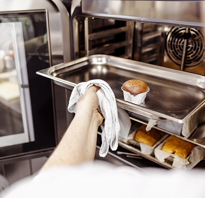 A picture of muffins baked in a commercial oven.