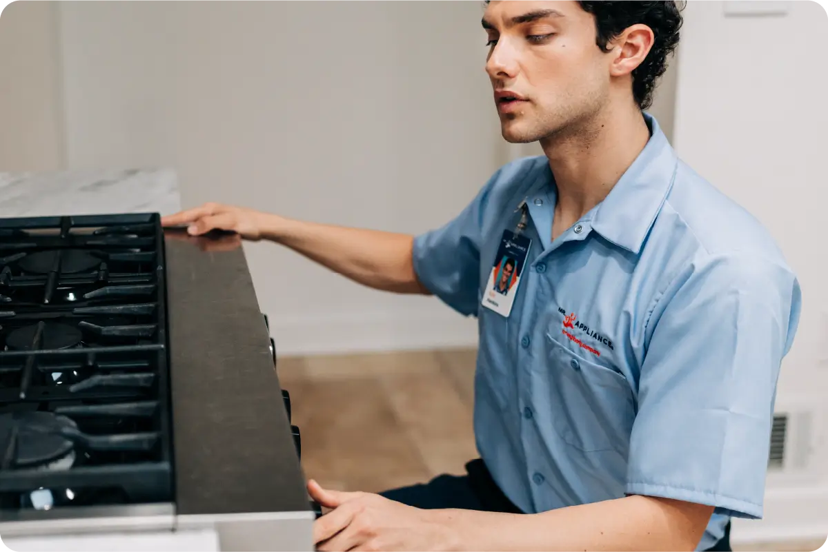 Image of a man looking at a gas stove.