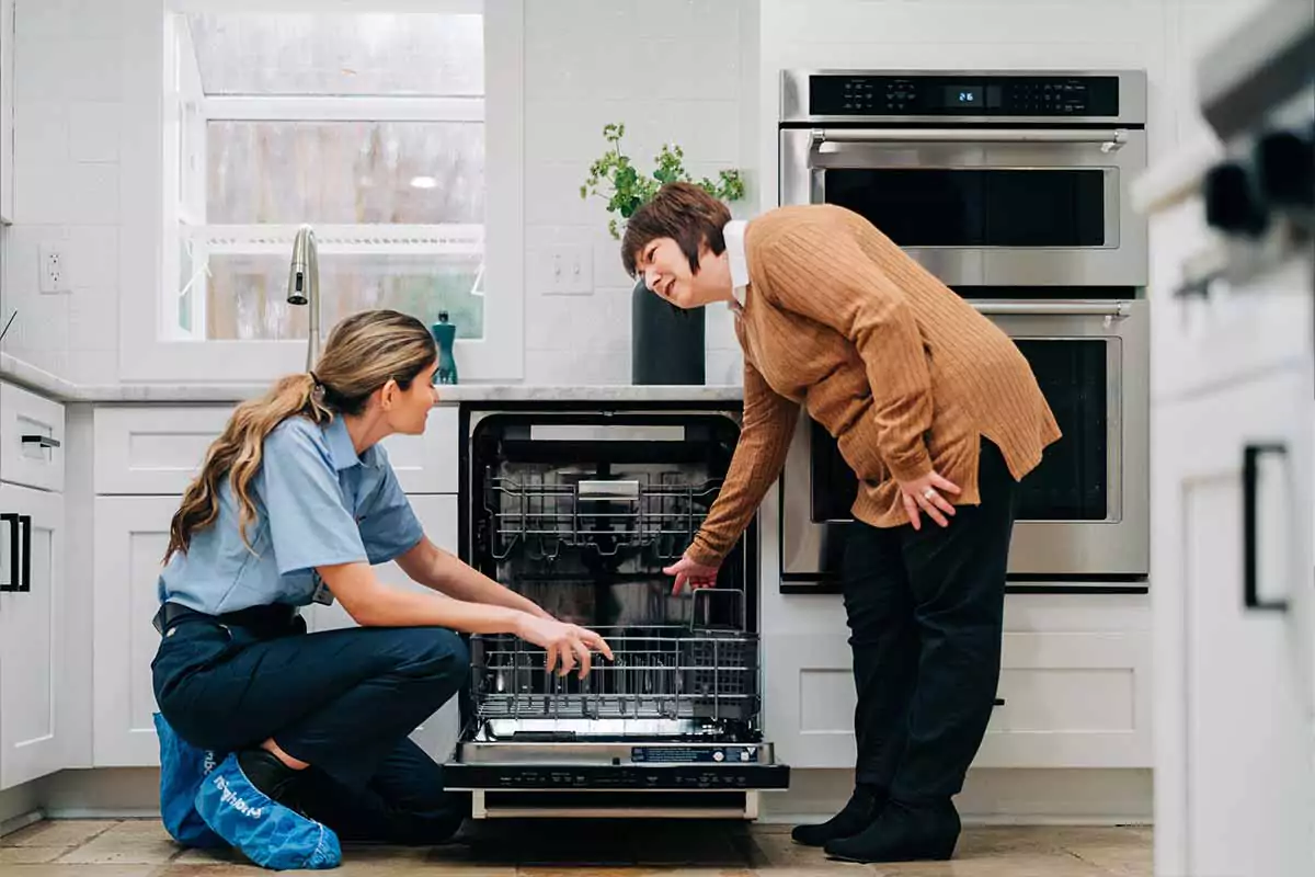  A service professional from Mr. Appliance helps fix a homeowner’s appliances.