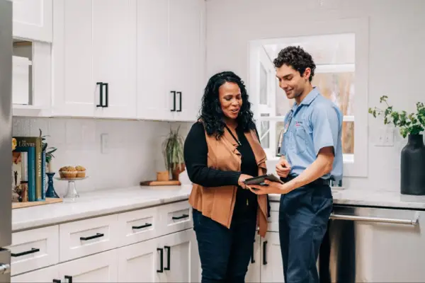 Mr. Appliance professional and customer looking at iPad