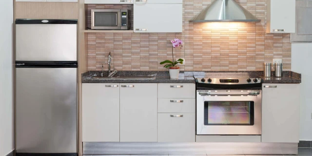 Kitchen with refrigerator, microwave, and oven range