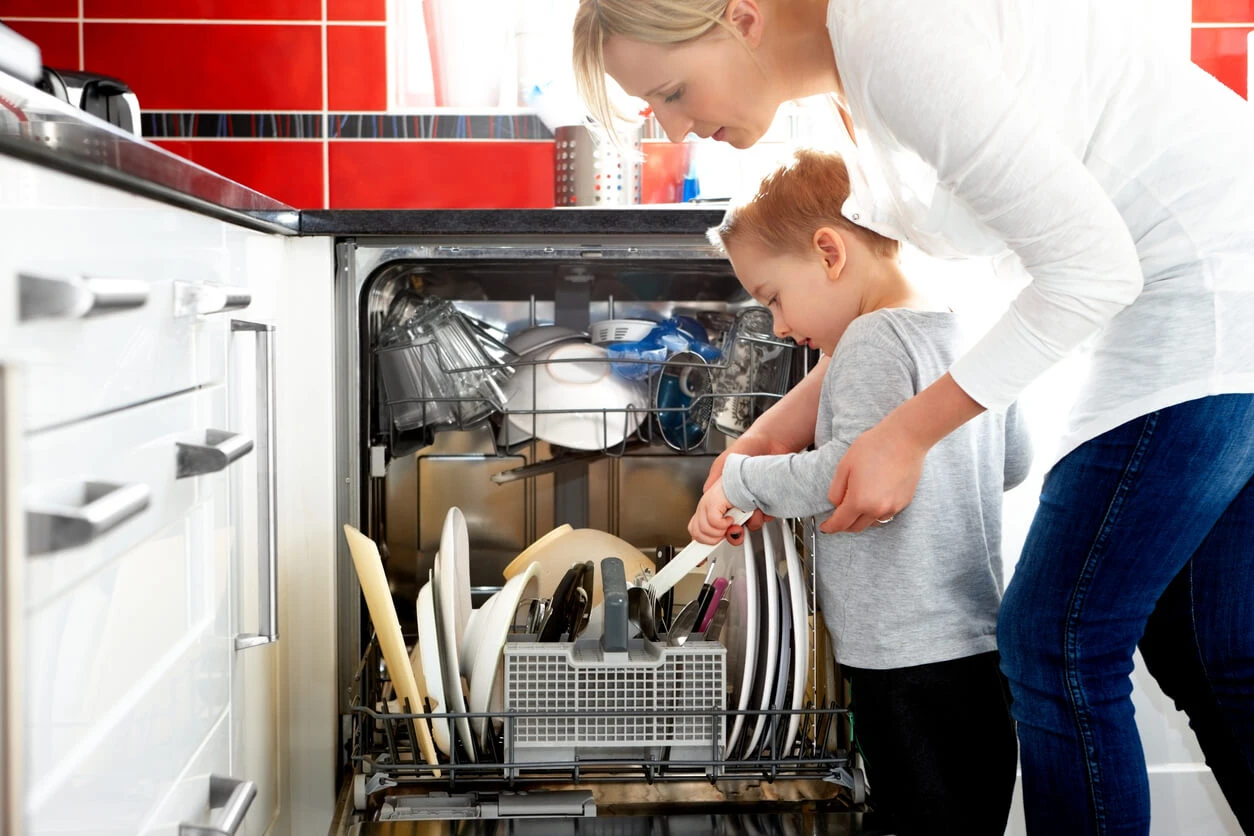 Mom and child filling dishwasher