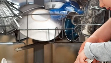 Mom and child filling dishwasher