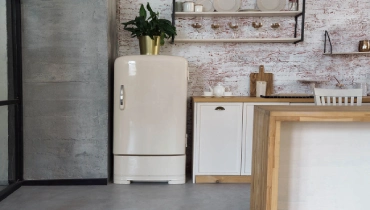Cream-colored vintage fridge in an industrial kitchen