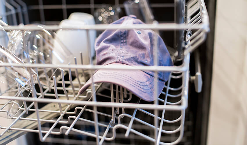 Baseball cap in a dishwasher's top rack