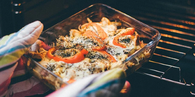 Person taking food out of an oven