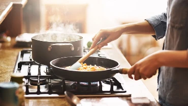 Cropped shot of a young woman preparing a meal at home | Mr. Appliance of Memphis