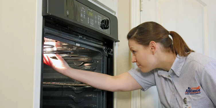 Mr. Appliance employee repairing an oven