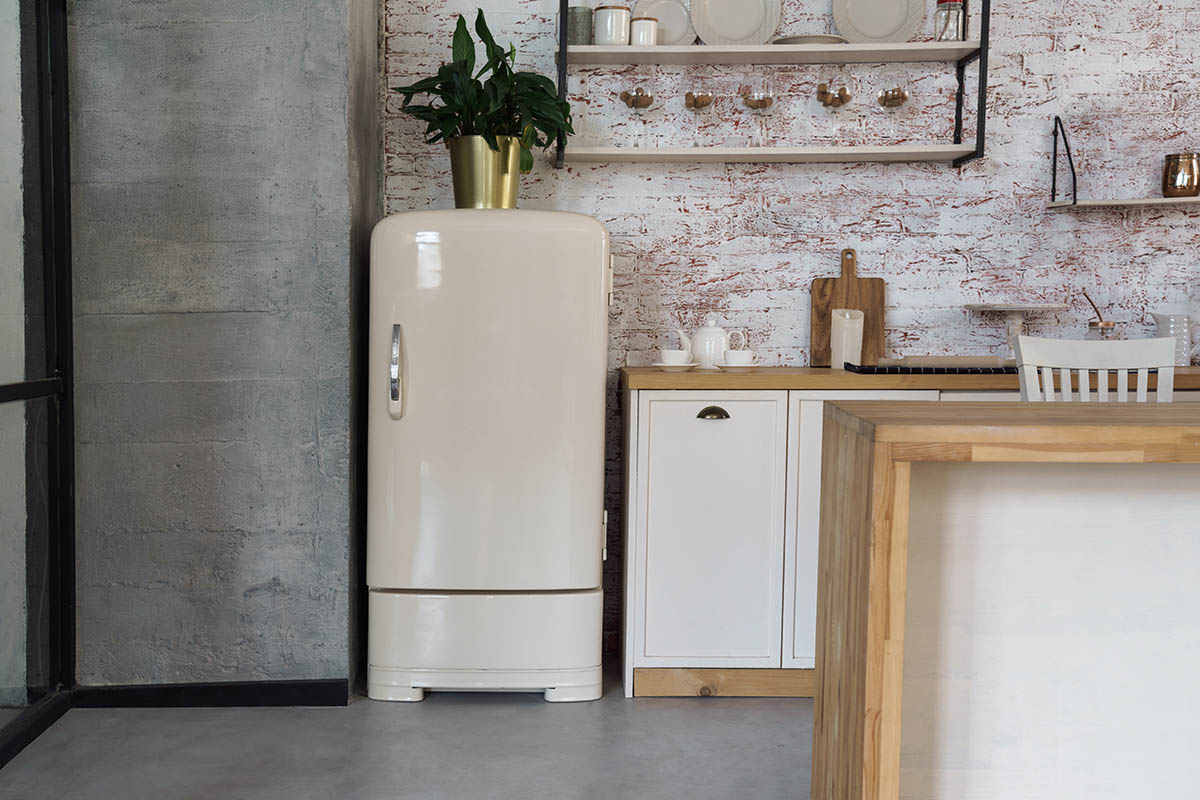 Cream-colored vintage fridge in an industrial kitchen