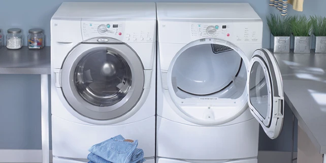 Folded jeans next to washer and dryer