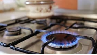 gas burner with blue flame on stovetop