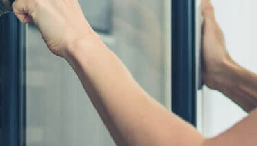 Woman opening wine refrigerator