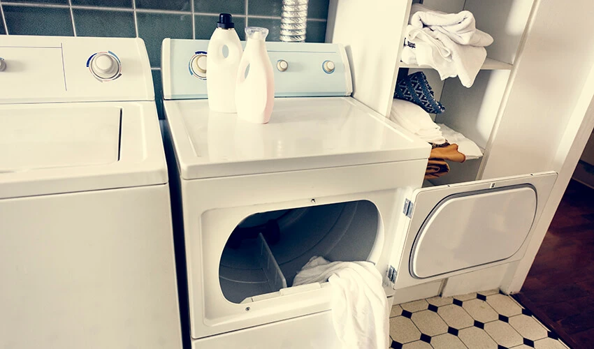 White side-by-side washer and dryer with the front-load dryer’s door open