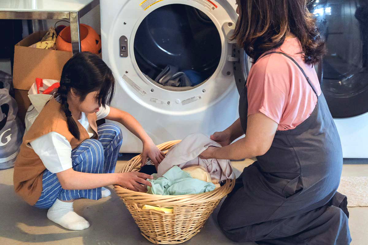 Mother and daughter doing laundry