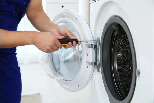 service professional working on washing machine