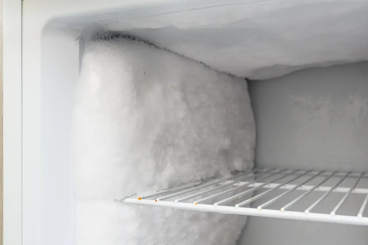 Inside of a freezer that has a build-up of frost.