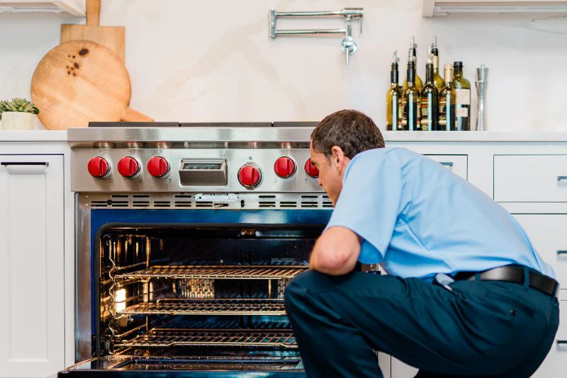 Mr. Appliance tech working on oven repair 