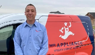 Mr. Appliance service professional in front of branded service truck