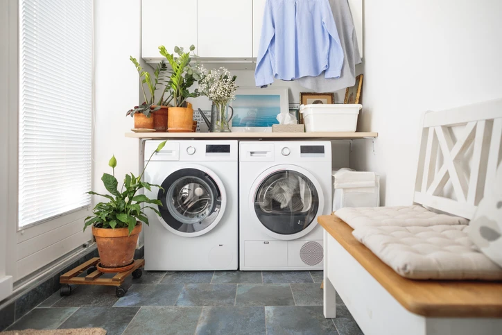 Front shot of a washer and dryer in a clean and organized laundry room