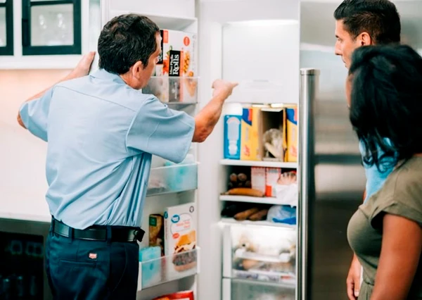 Mr. Appliance technician discussing freezer repairs