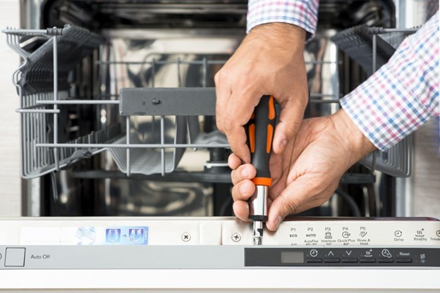 Mr. Appliance service professional repairing a dishwasher.