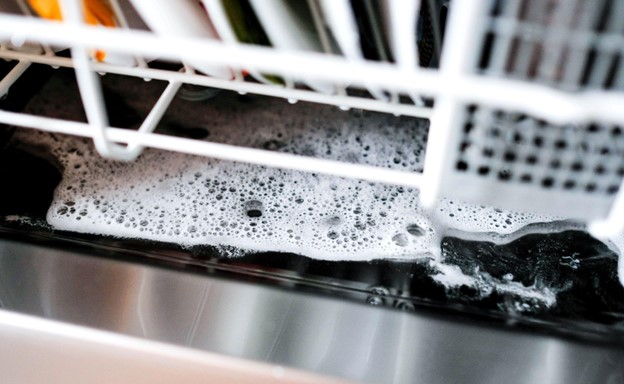 Excess detergent at the bottom of the dishwasher.