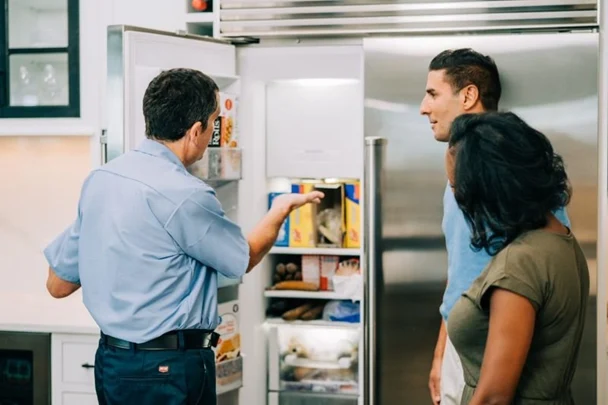 Mr.appliance tech working on refrigerator ice maker repairs