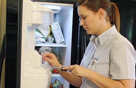 Technician fixing a fridge ice make