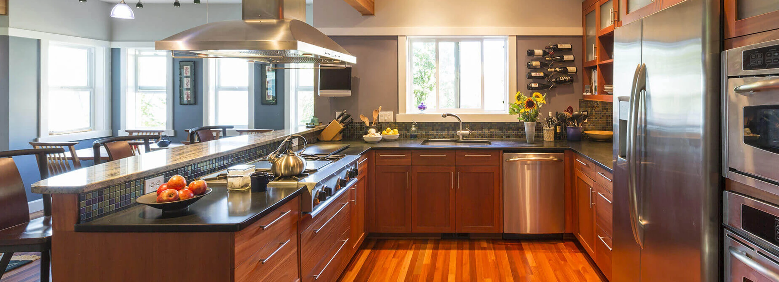 Modern open concept kitchen with new stainless steel appliances.