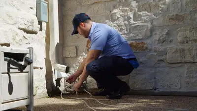 A Mr. Appliance tech cleaning a dryer vent