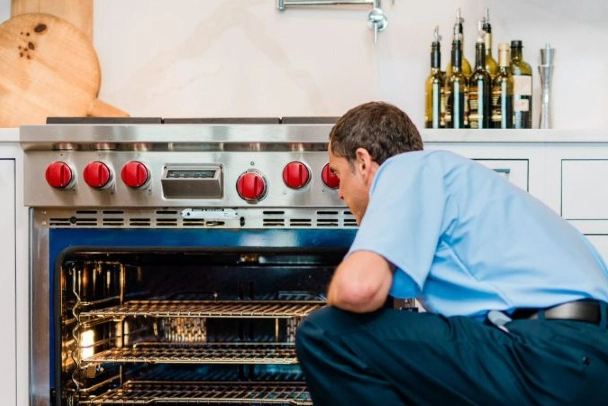 Mr. Appliance tech working on oven repair.