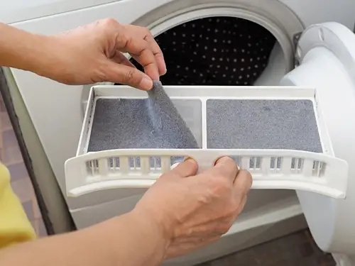 Cleaning a dryer lint trap.