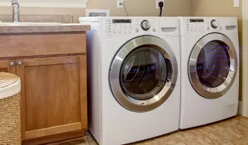 Laundry room with a white front-load washer and dryer set.