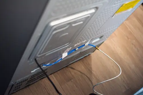 Rear view of a refrigerator showing water line for ice maker.