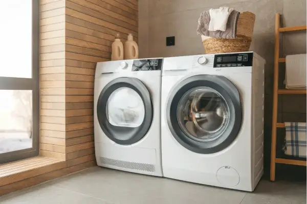 Front-load washer and dryer side-by-side in a laundry room.