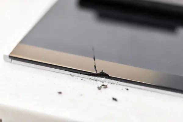 Chip on a glass-ceramic stovetop.