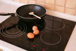 Pan and eggs on a hot glass top stove.