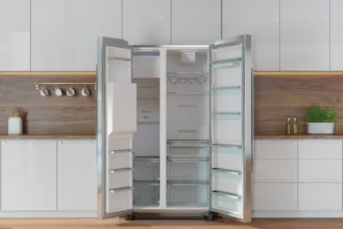 A refrigerator with open doors awaiting refrigerator repair in a clean, modern kitchen