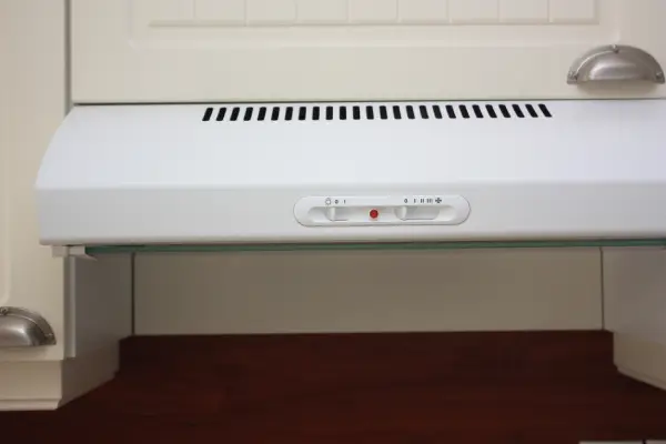 White under-cabinet, ductless vent fan.