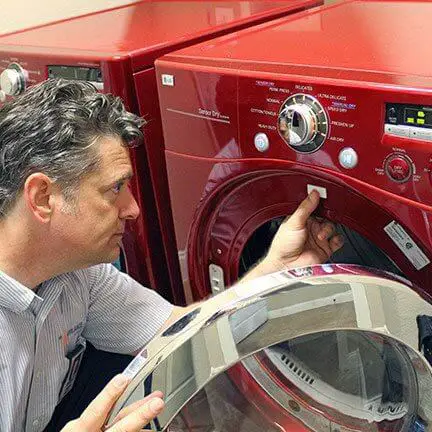 Mr. Appliance tech working on a washing machine.