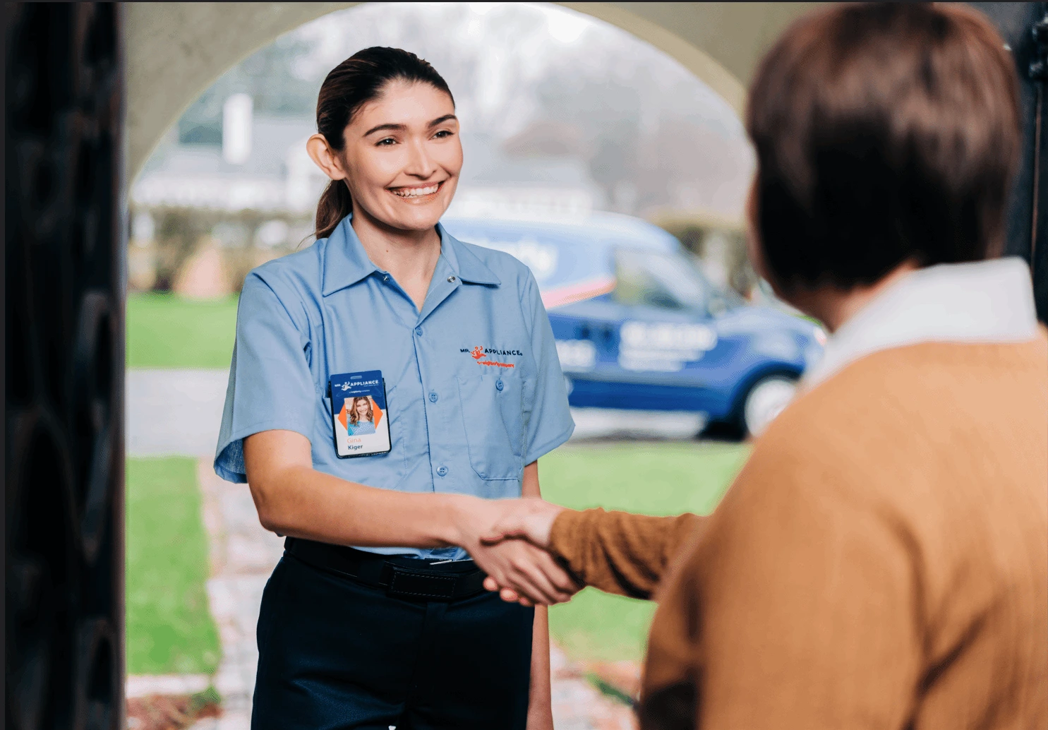 Mr. Appliance service professional greeting homeowner.